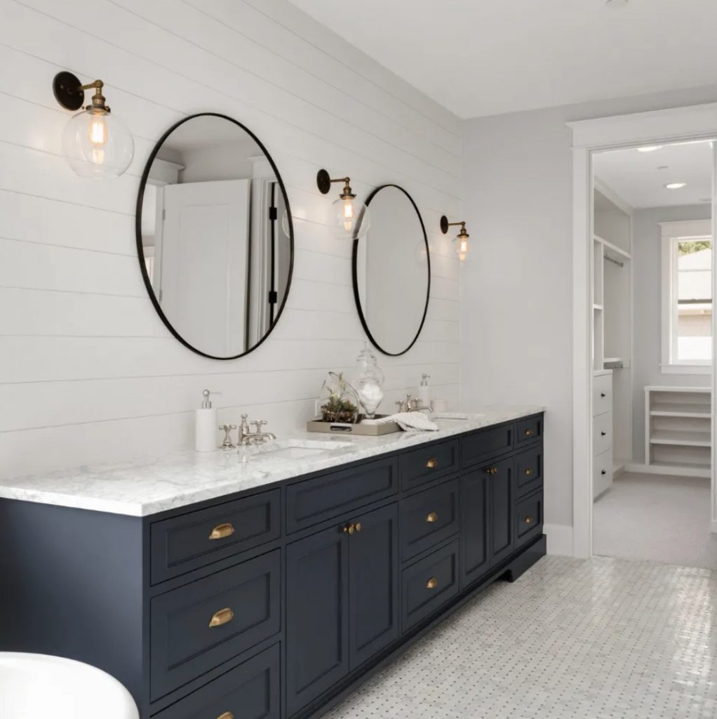Modern bathroom with large circular mirrors and dark cabinets - Newton MA Bathroom Remodeling Exponential Construction Corp.