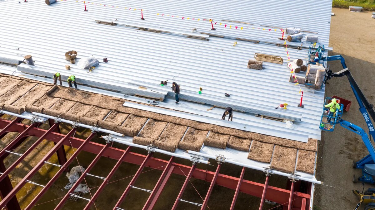 Commercial metal roof installation in progress on Massachusetts business property